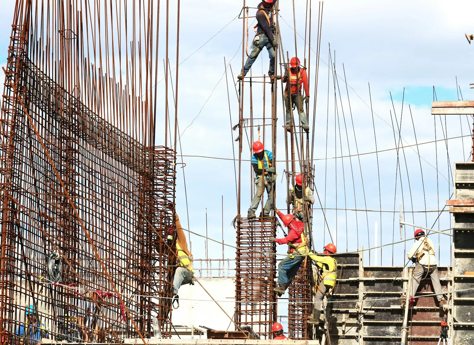 Construction workers on steel reinforcement during the day